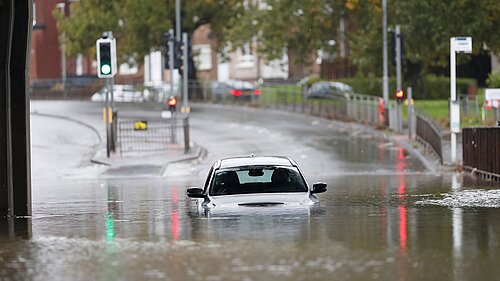 A car covered up with water after a flood.