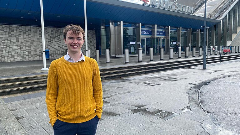 Henry Wright standing outside of the Reading Station entrance